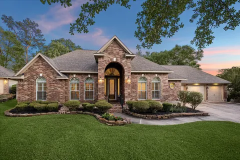 a front view of a house with a yard and porch