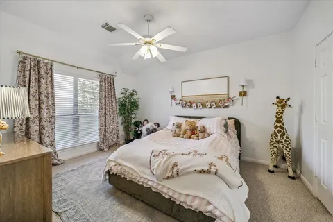 a bedroom with a large bed and a chandelier