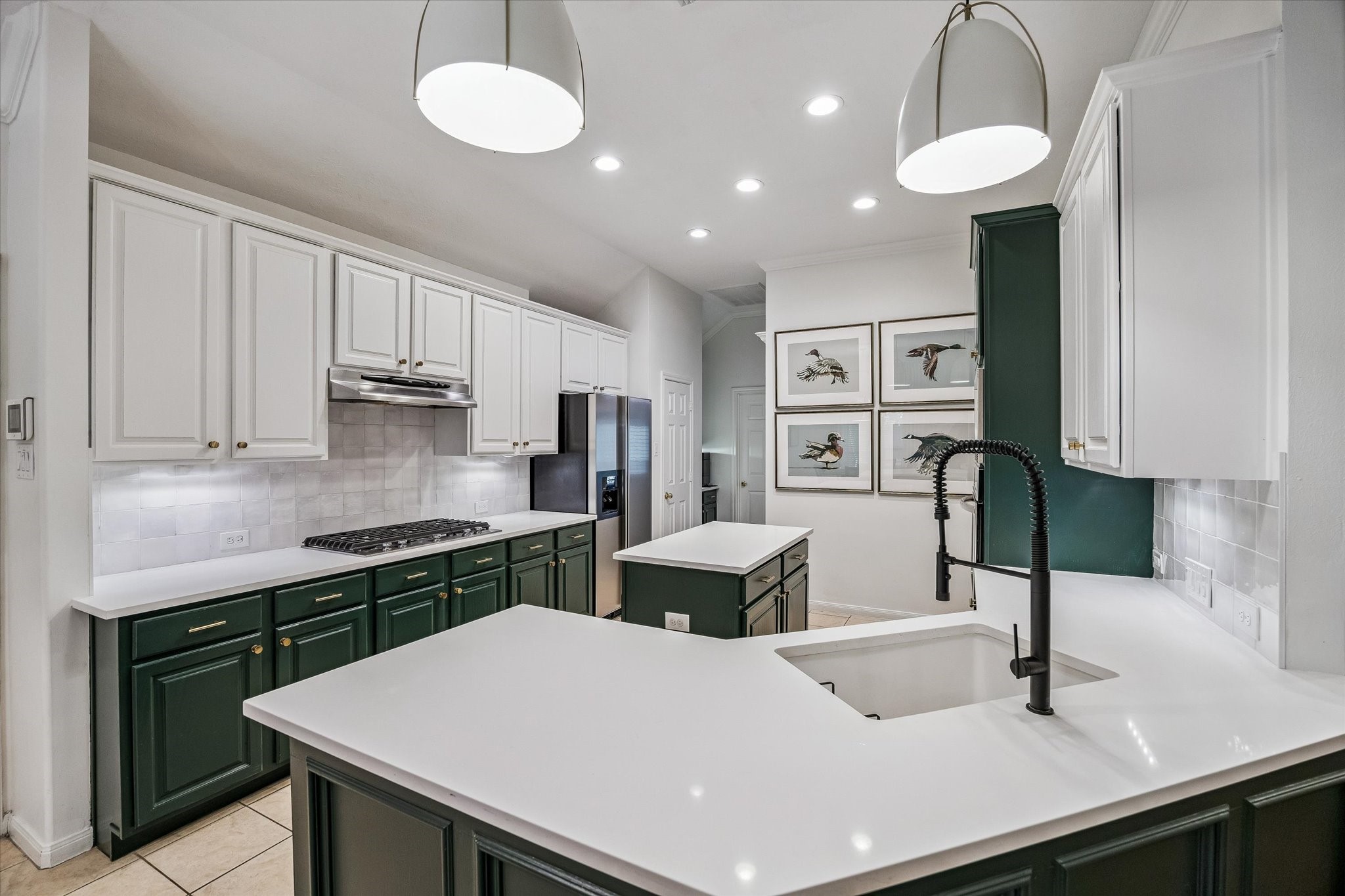 6507 Haughton Court Spring, TX 77389 - Photo 6 of 24 a kitchen with a refrigerator a sink cabinets and wooden floor