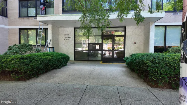 front view of a brick house with large windows