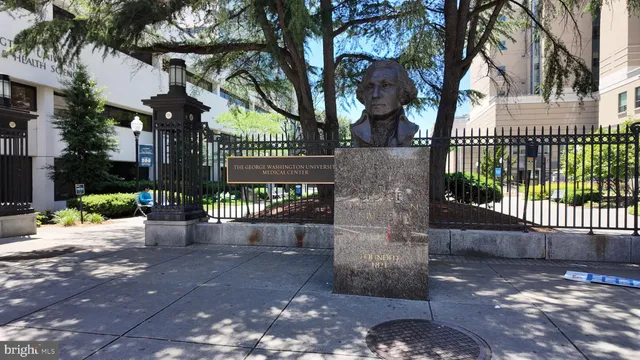 a view of a pathway of a house with a bench in patio
