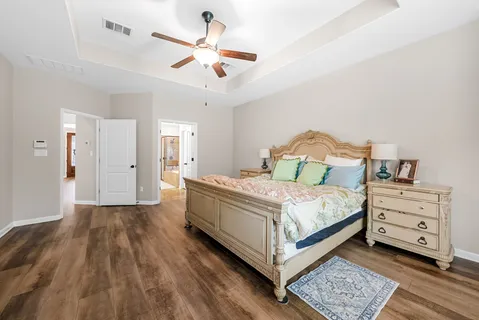 a bedroom with a bed and a chandelier