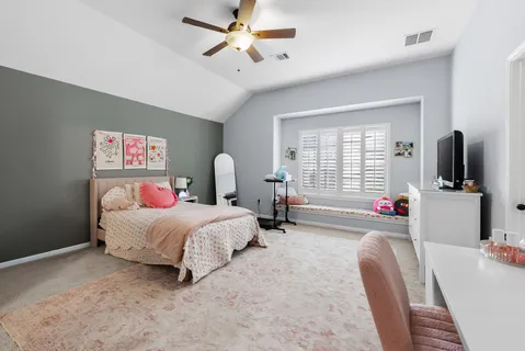 a bedroom with bed and a flat screen tv