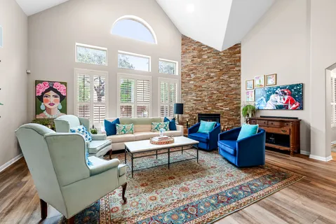 a living room with furniture a rug and a window