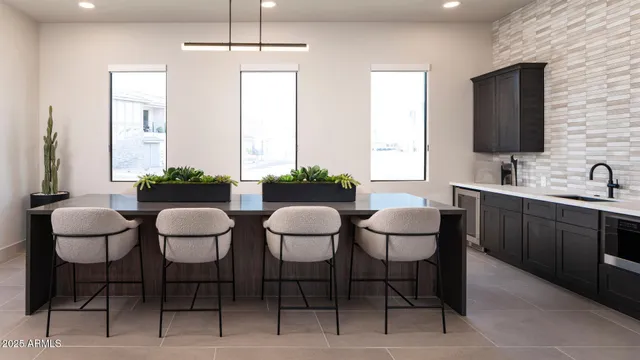 a view of a dining room with chairs and chandelier