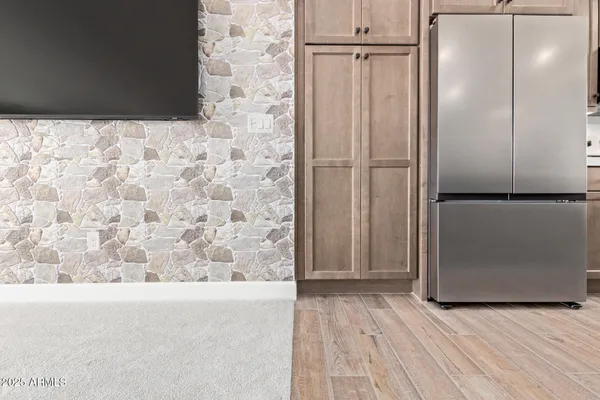 a kitchen with stainless steel appliances granite countertop a sink a stove and a refrigerator