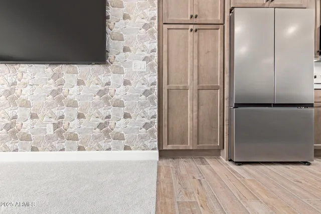 a kitchen with stainless steel appliances granite countertop a sink a stove and a refrigerator