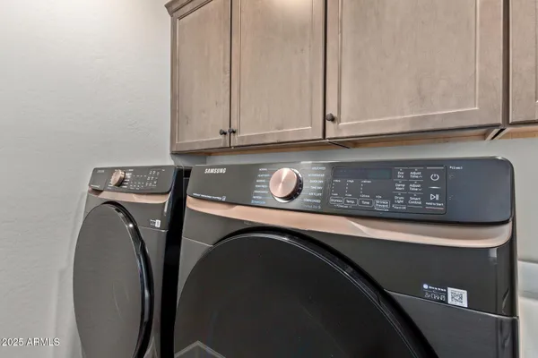a kitchen with stainless steel appliances kitchen island a refrigerator and a sink