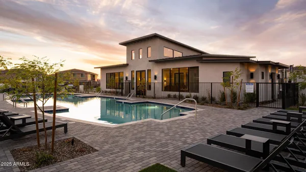 a view of a house with swimming pool and sitting area