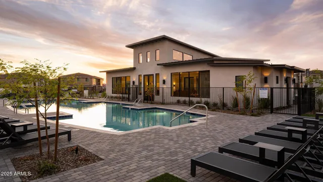 a view of a house with swimming pool and sitting area