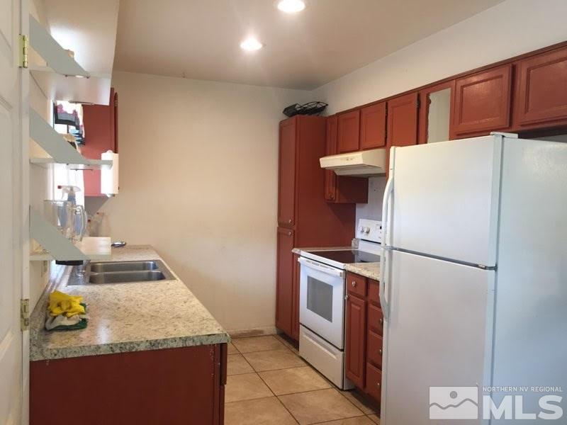 1201 Butler Street Reno, NV 89512 - Photo 2 of 7 a white refrigerator freezer and a stove