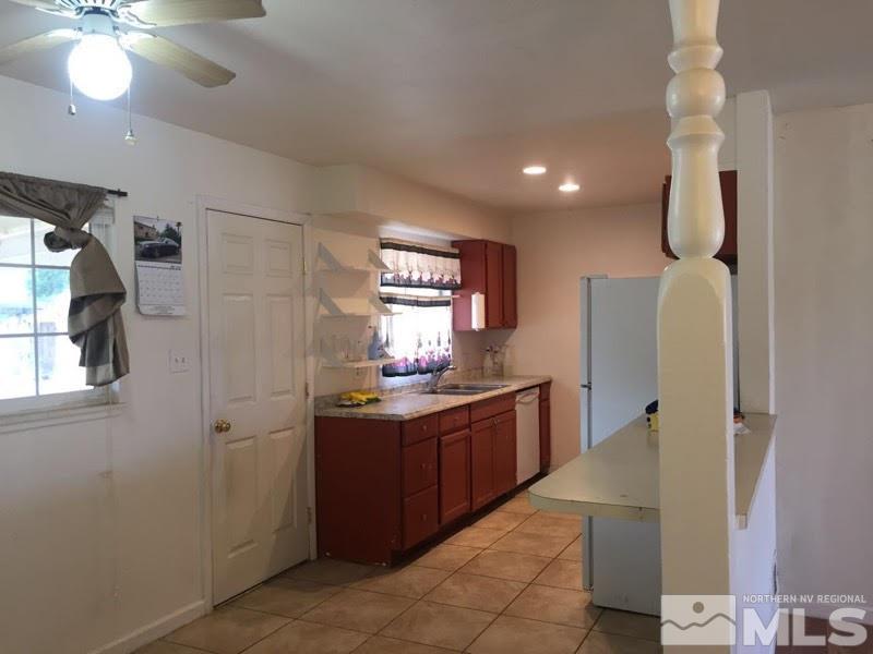 1201 Butler Street Reno, NV 89512 - Photo 3 of 7 a kitchen with granite countertop a refrigerator and a sink