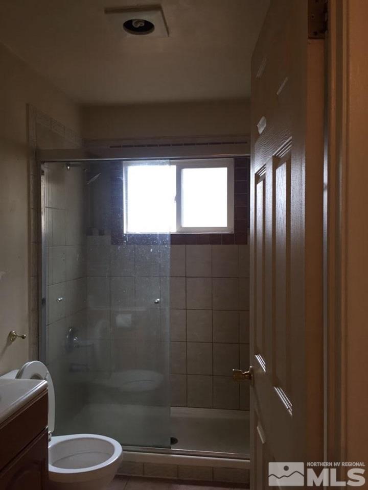 1201 Butler Street Reno, NV 89512 - Photo 6 of 7 a bathroom with a shower a toilet and a sink