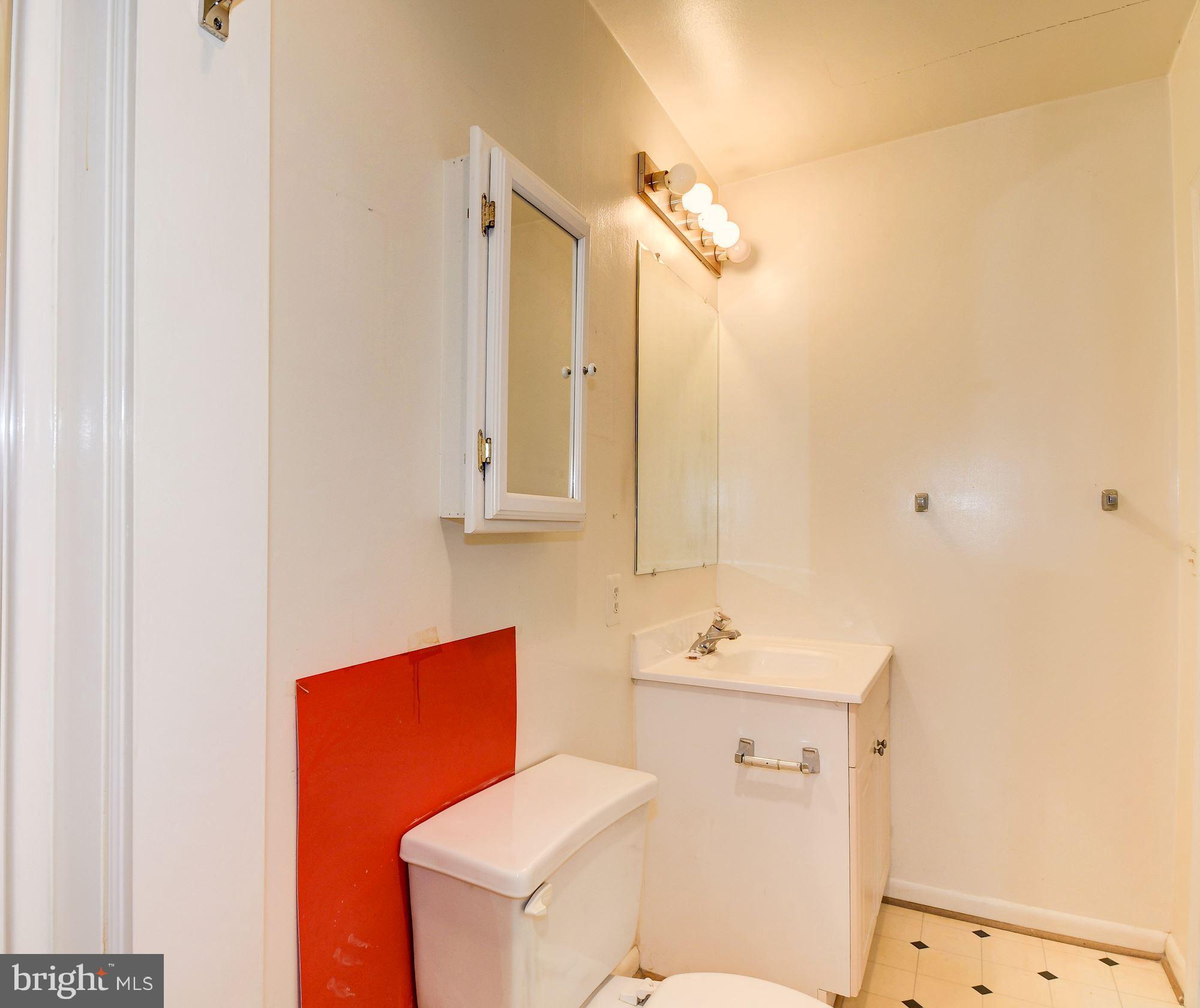 1218 Portner Road Alexandria, VA 22314 - Photo 26 of 31 a bathroom with a sink a toilet and mirror