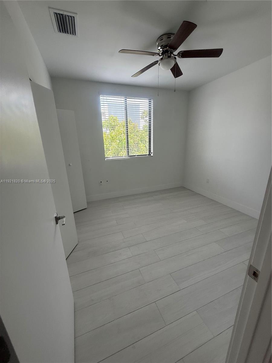 909 East 24th Street, Unit 403 Hialeah, FL 33013 - Photo 12 of 20 a view of an empty room with a window