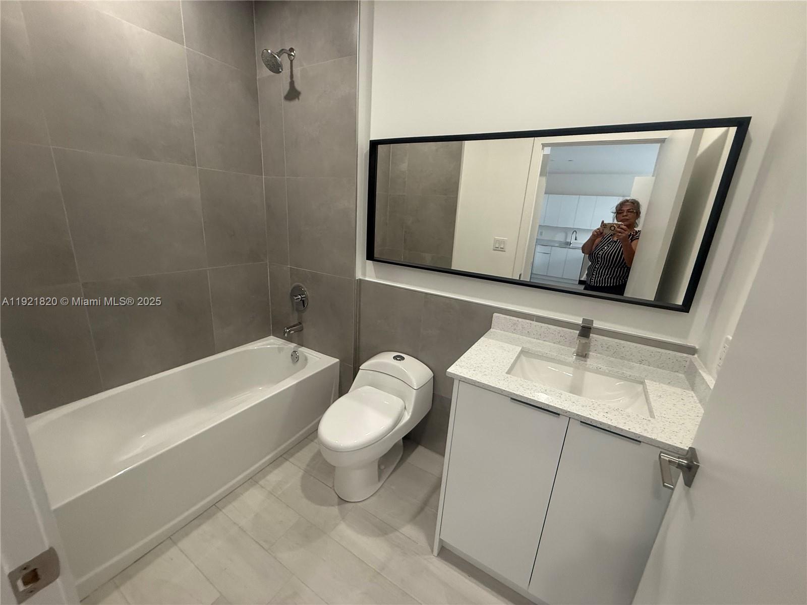 909 East 24th Street, Unit 403 Hialeah, FL 33013 - Photo 16 of 20 a bathroom with a sink and a mirror