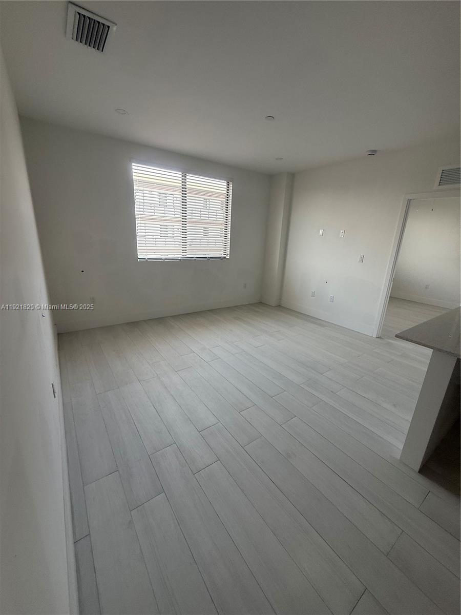 909 East 24th Street, Unit 403 Hialeah, FL 33013 - Photo 2 of 20 an empty room with windows