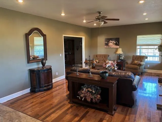a living room with furniture a fireplace and a flat screen tv