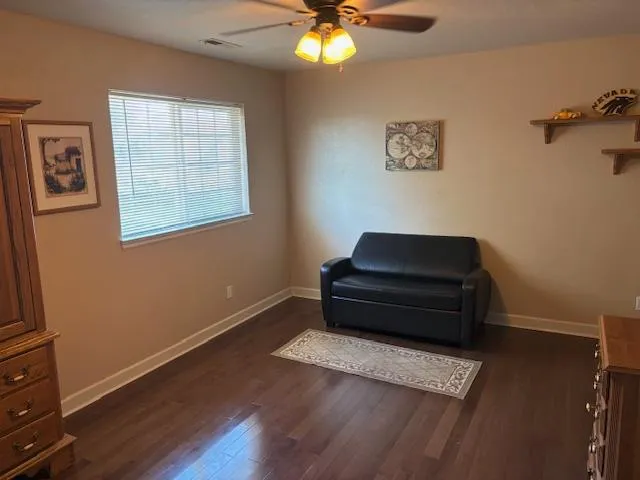 a small space with wooden floor and a window