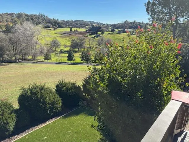 a view of a hallway with wooden floor and a bedroom