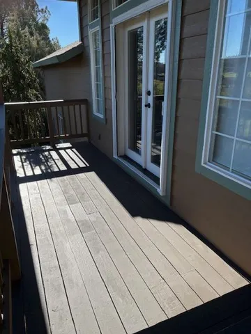 a view of balcony with wooden floor