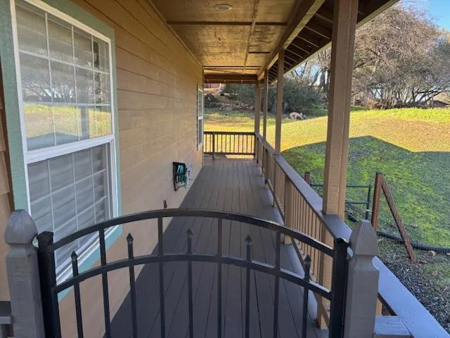 a view of balcony with a large window and wooden floor