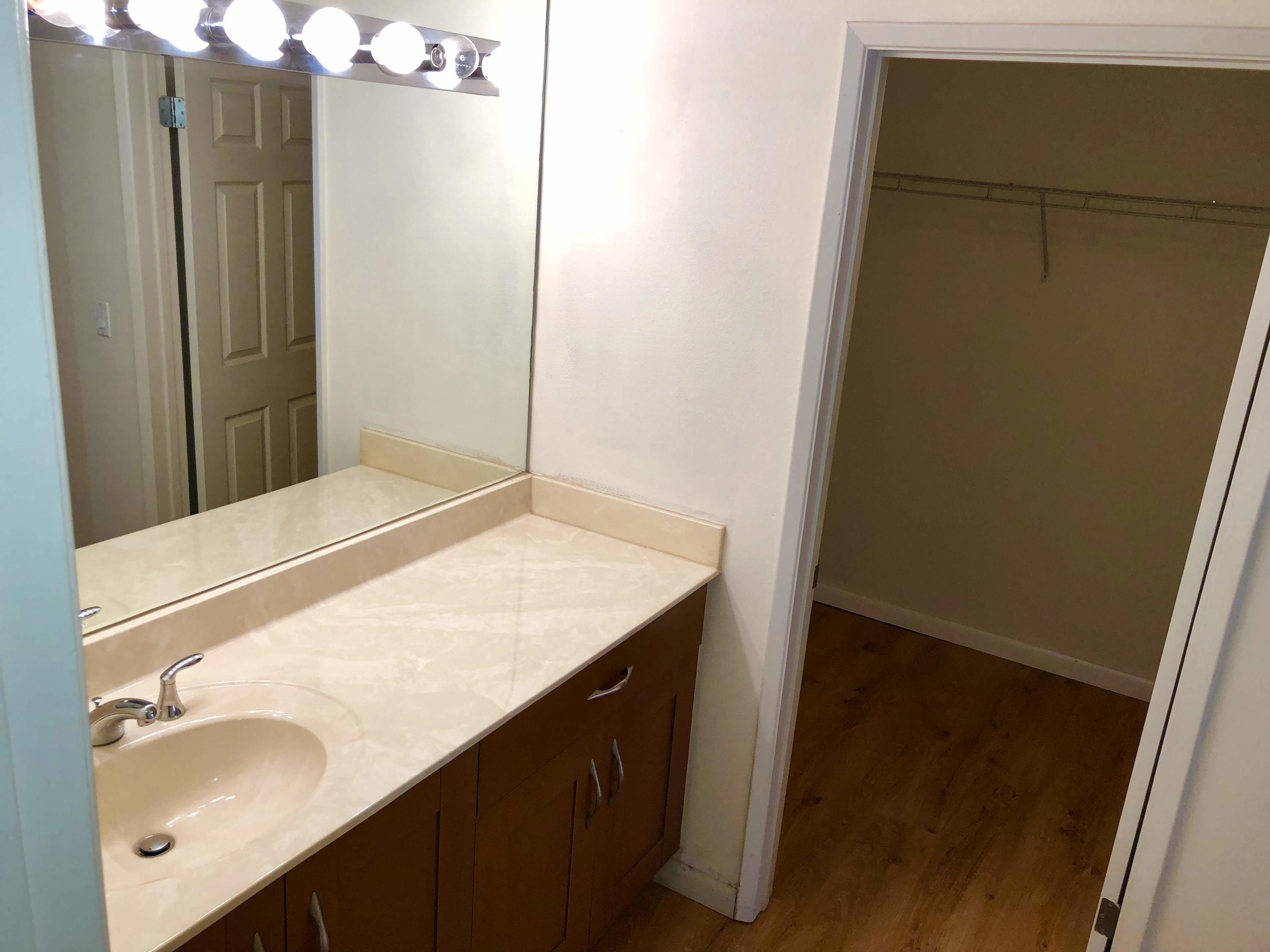 3133 Clint Moore Road, Unit 201 Boca Raton, FL 33496 - Photo 13 of 15 a bathroom with a sink and a mirror
