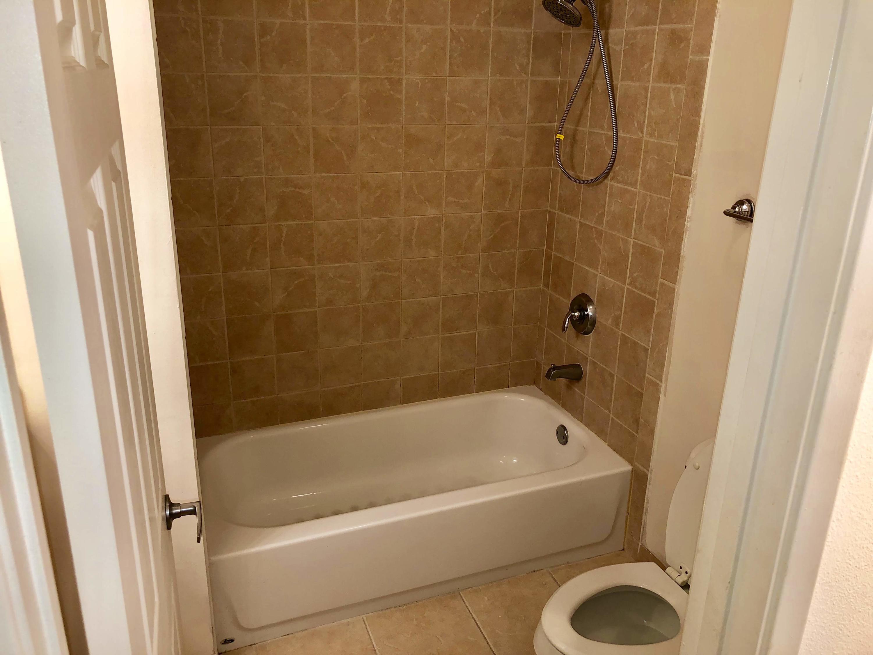 3133 Clint Moore Road, Unit 201 Boca Raton, FL 33496 - Photo 14 of 15 a white bath tub and shower