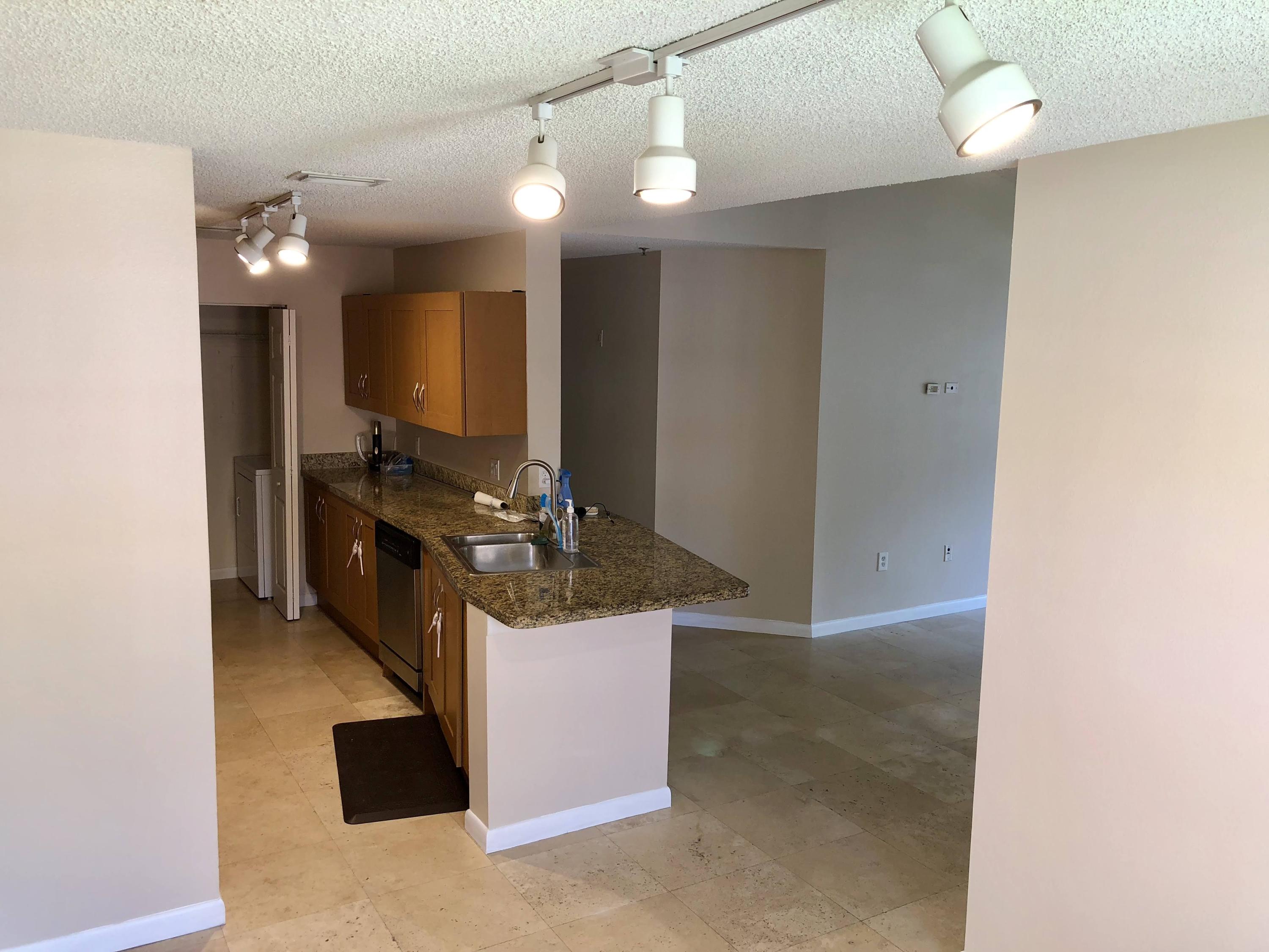 3133 Clint Moore Road, Unit 201 Boca Raton, FL 33496 - Photo 6 of 15 a kitchen with stainless steel appliances granite countertop a sink a stove and a refrigerator