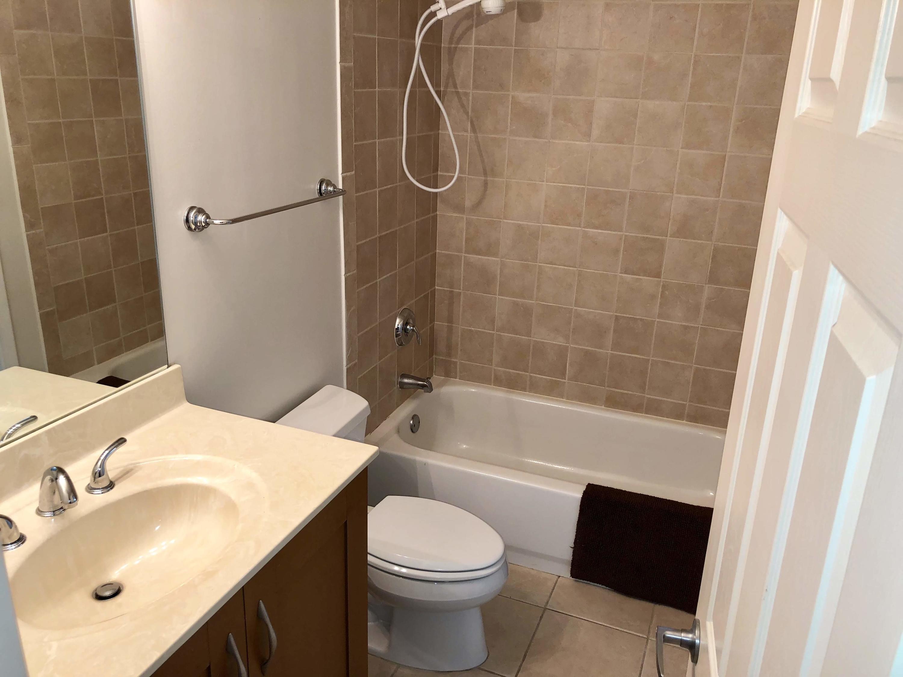 3133 Clint Moore Road, Unit 201 Boca Raton, FL 33496 - Photo 10 of 15 a bathroom with a sink toilet and shower