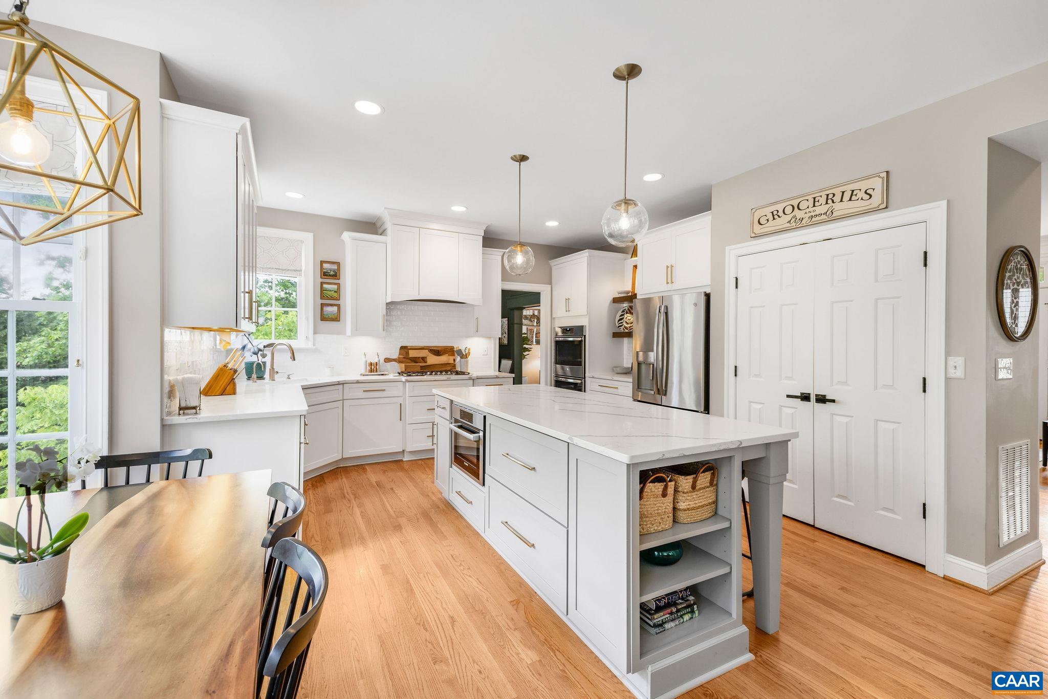 3399 Darby Road Keswick, VA 22947 - Photo 17 of 73 a large kitchen with stainless steel appliances granite countertop a lot of counter space and wooden floors