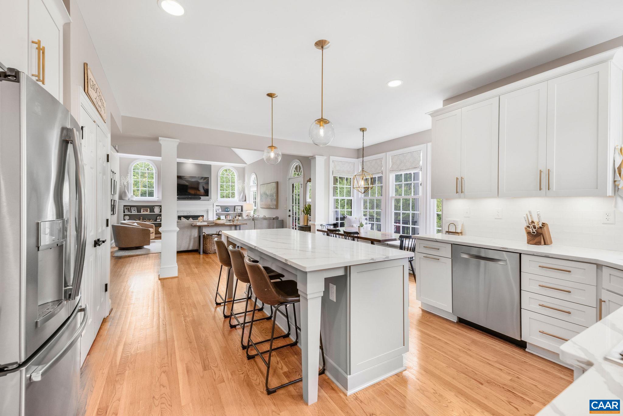3399 Darby Road Keswick, VA 22947 - Photo 21 of 73 a open kitchen with stainless steel appliances granite countertop a stove top oven a refrigerator a sink and white cabinets with wooden floor