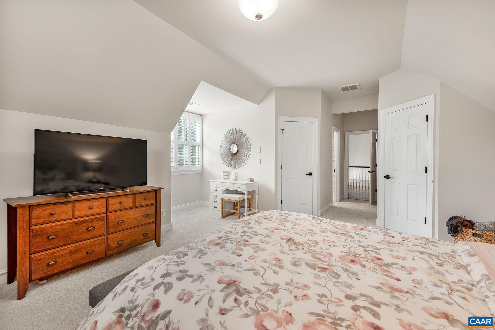 3399 Darby Road Keswick, VA 22947 - Photo 42 of 73 a bedroom with a large bed and flat screen tv