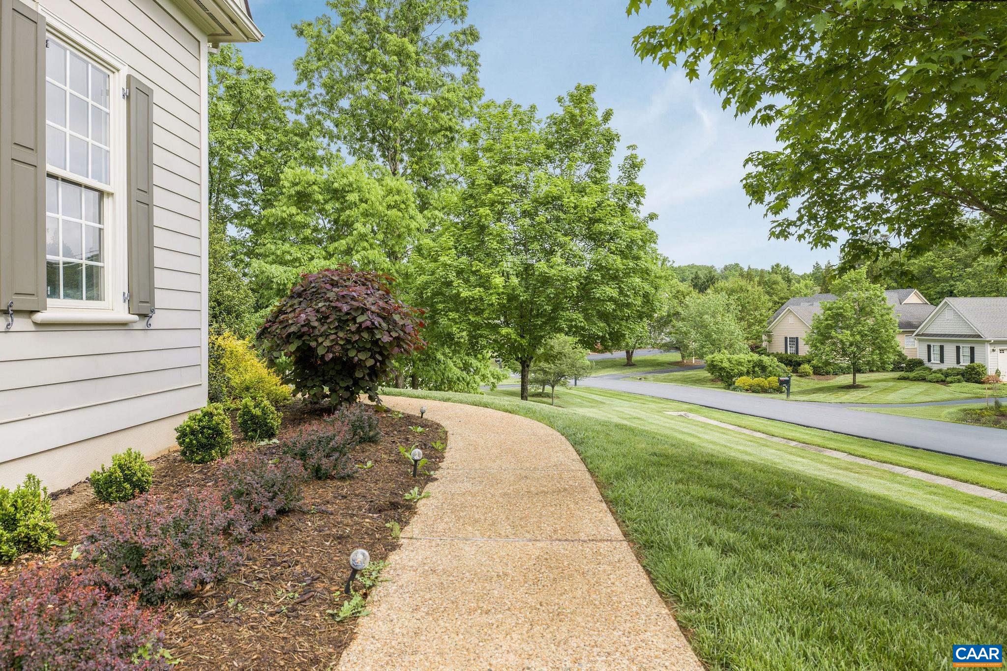 3399 Darby Road Keswick, VA 22947 - Photo 56 of 73 a front view of a house with a yard and fountain in middle