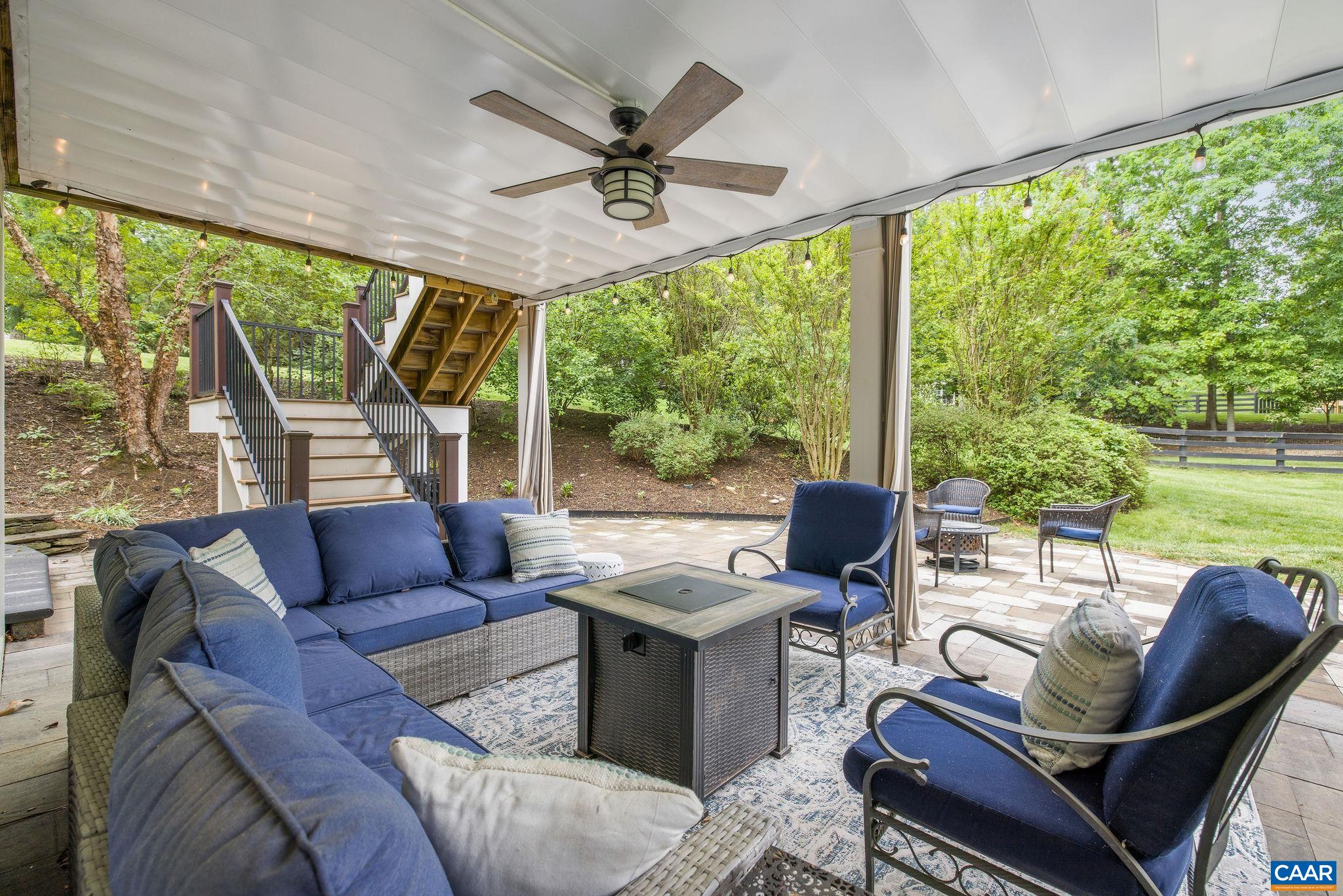3399 Darby Road Keswick, VA 22947 - Photo 65 of 73 a living room with patio furniture and a floor to ceiling window