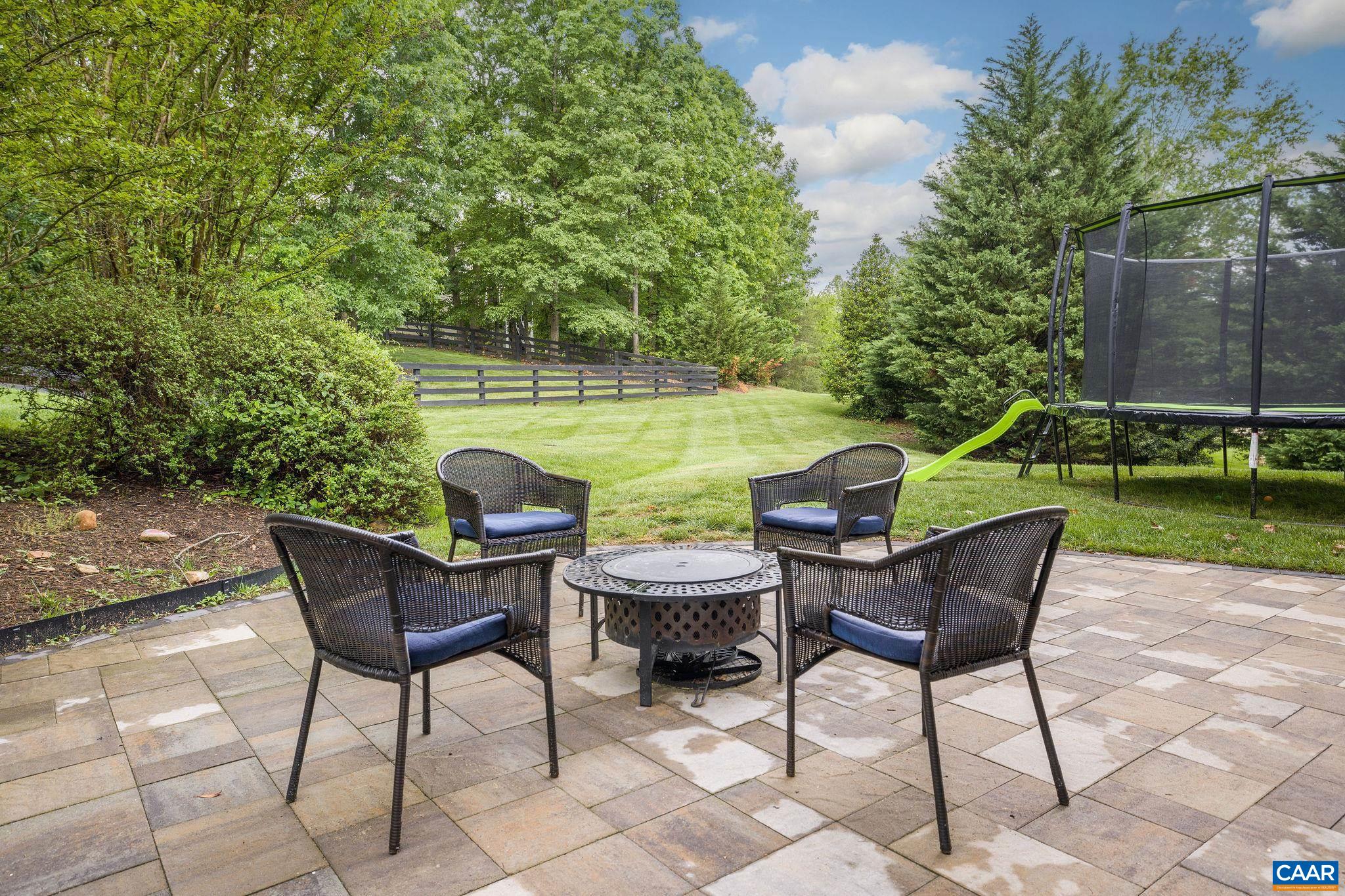 3399 Darby Road Keswick, VA 22947 - Photo 66 of 73 a view of a chairs and table in the patio in a backyard