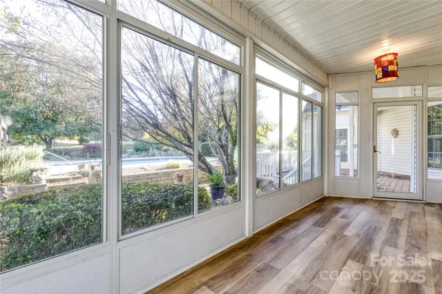 a view of a porch with wooden floor and windows