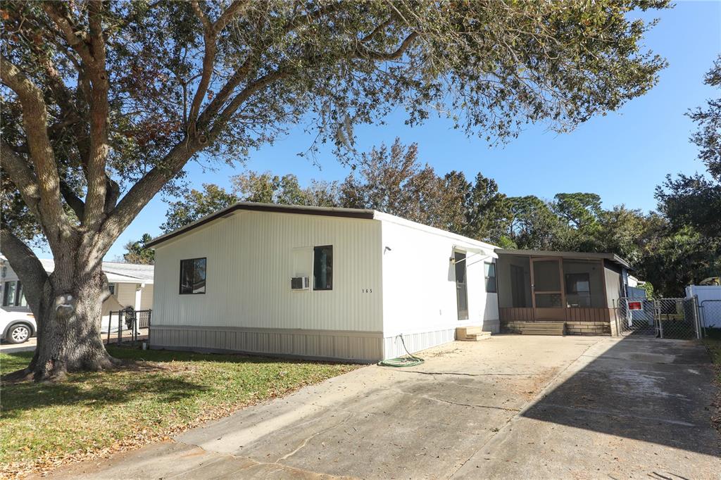 165 Moss Drive DeBary, FL 32713 - Photo 1 of 1 a house with a tree in front of it
