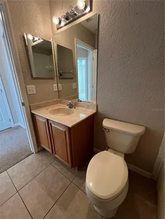 an empty room with a ceiling fan and window