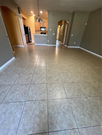 a large kitchen with stainless steel appliances a large counter top a stove a microwave a sink and a refrigerator