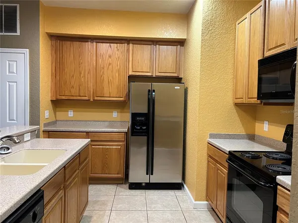 a kitchen with a sink stove and refrigerator