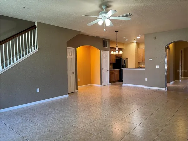 a kitchen with granite countertop a sink a stove top oven and cabinets