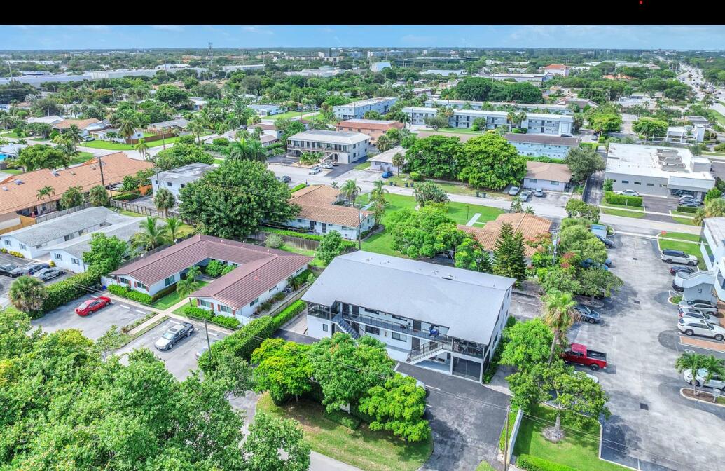 an aerial view of residential houses with outdoor space and street view