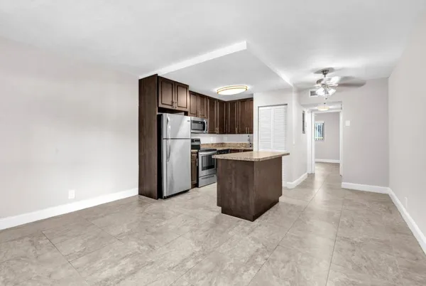 a kitchen with stainless steel appliances a refrigerator and a stove top oven