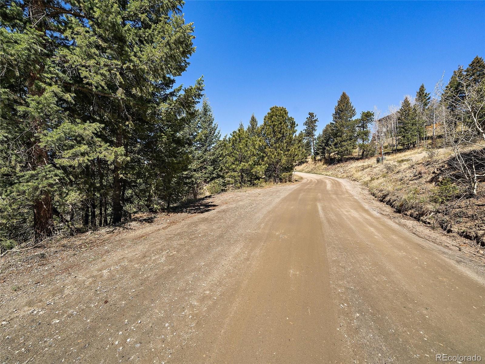 Lynx Lair Road Evergreen, CO 80439 - Photo 17 of 30 a view of a road with a building in the background
