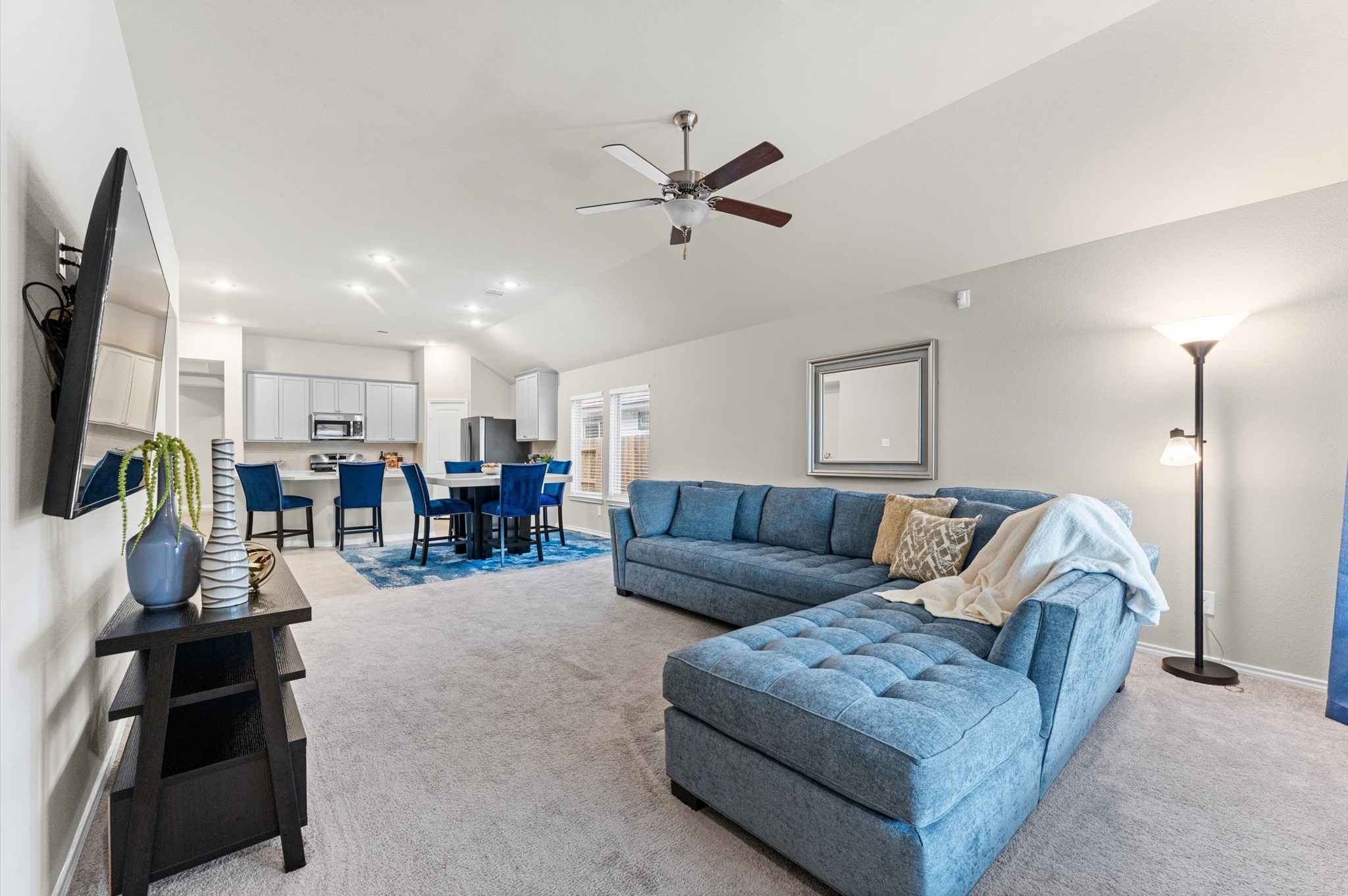 2702 Meadow View Lane Conroe, TX 77385 - Photo 14 of 26 a living room with furniture kitchen view and a flat screen tv