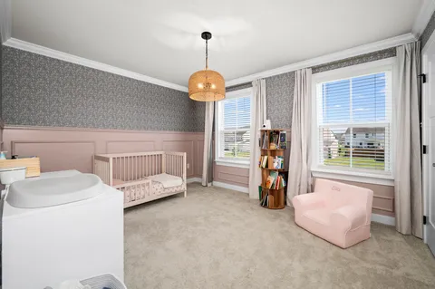 a bedroom with bed and a chandelier