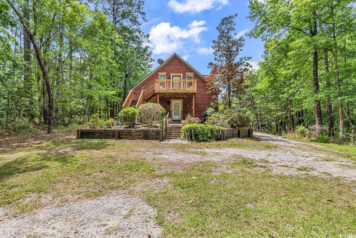 487 Trestle Way Conway, SC 29526 - Photo 27 of 40 View of front facade featuring stairway, a wooden deck, and brick siding