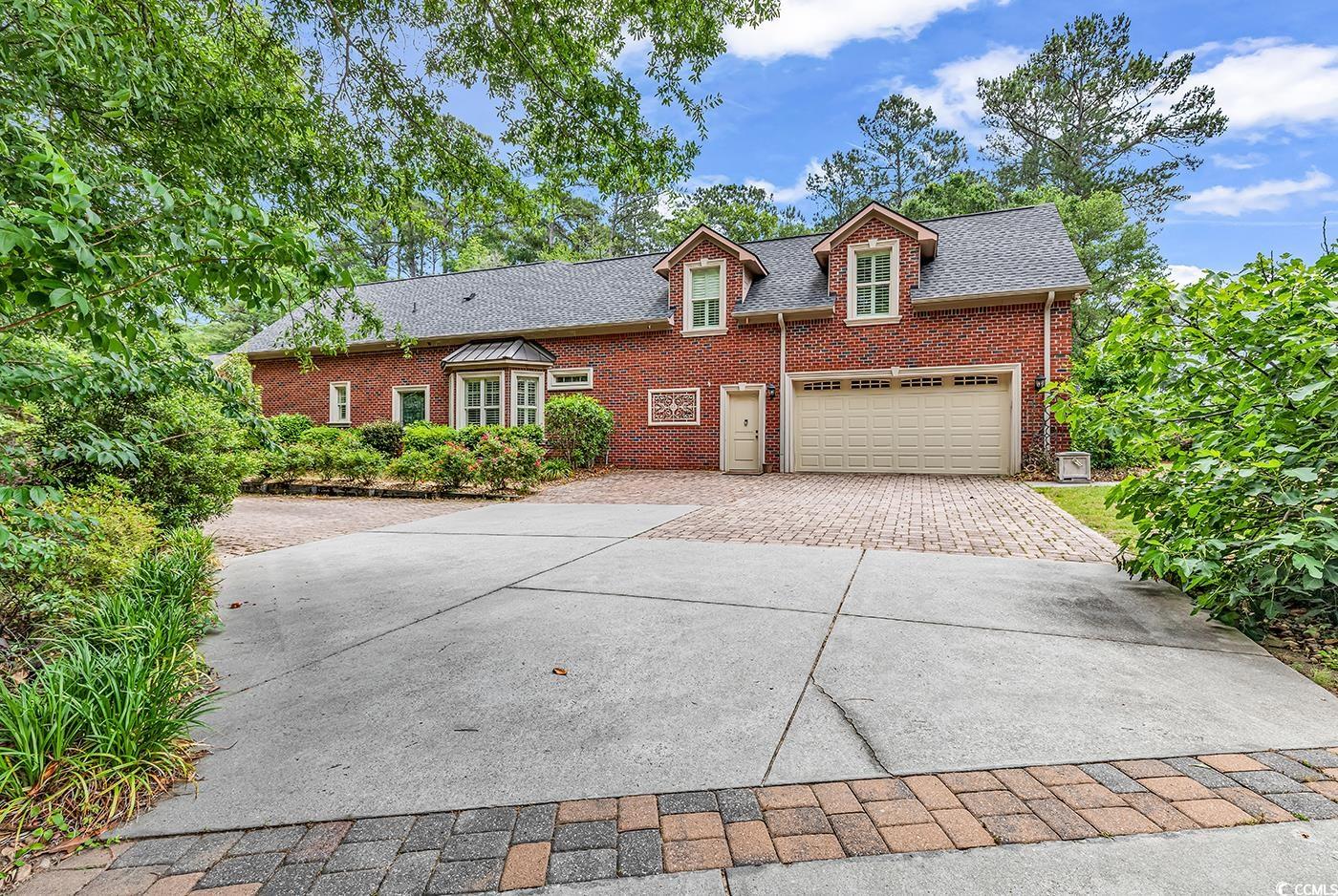 487 Trestle Way Conway, SC 29526 - Photo 32 of 40 View of front facade featuring driveway, brick siding, and a shingled roof