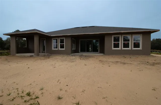 a view of a house with a wooden fence